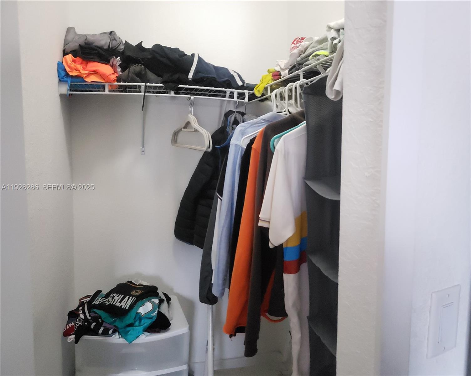 2414 Southwest 145th Place, Unit 2414 Miami, FL 33175 - Photo 22 of 29 a view of walk in closet with clothes and shoes