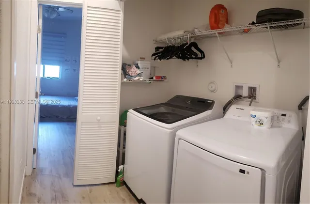 a view of a room with gym equipment and wooden floor