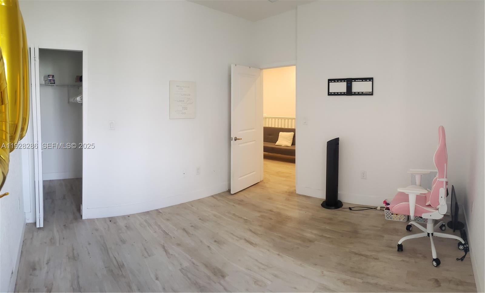 2414 Southwest 145th Place, Unit 2414 Miami, FL 33175 - Photo 24 of 29 a view of a room with gym equipment and wooden floor