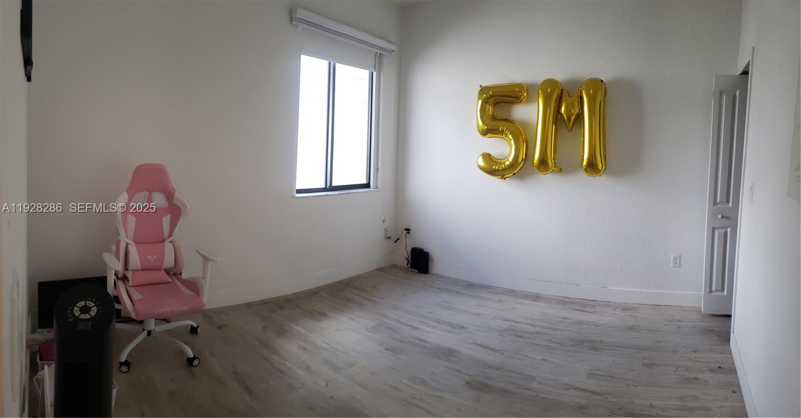 2414 Southwest 145th Place, Unit 2414 Miami, FL 33175 - Photo 25 of 29 a room with a window and flowerpot