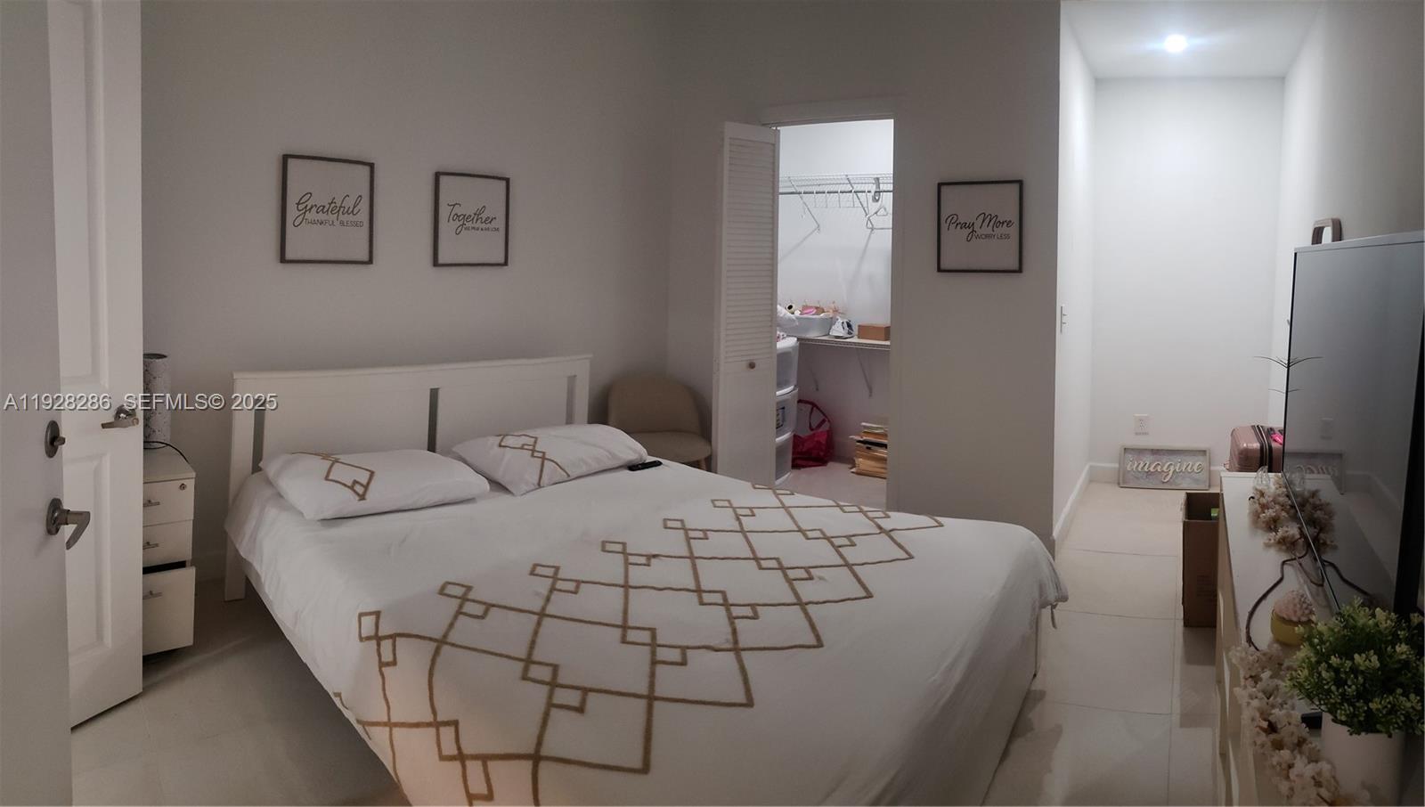 2414 Southwest 145th Place, Unit 2414 Miami, FL 33175 - Photo 27 of 29 a bedroom with a bed and a table in it