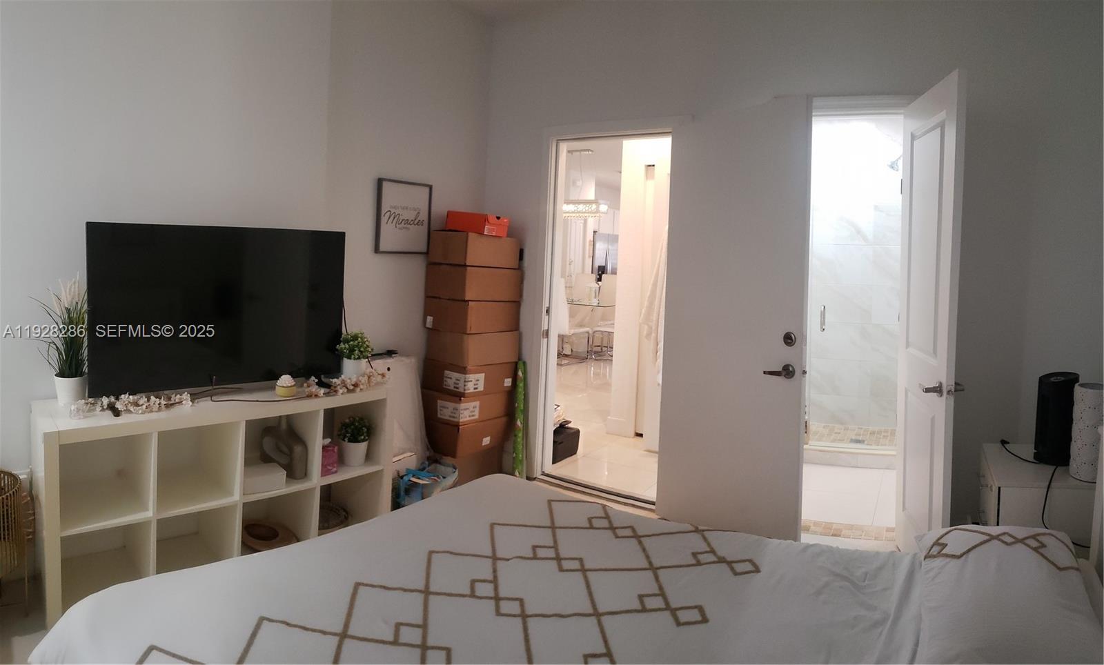 2414 Southwest 145th Place, Unit 2414 Miami, FL 33175 - Photo 28 of 29 a bedroom with a bed and a flat screen tv