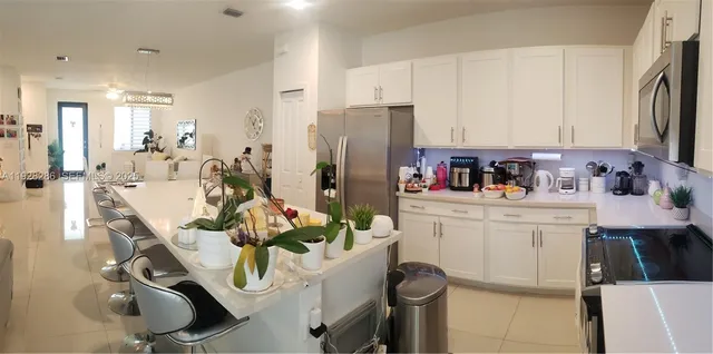 a view of a dining room and livingroom with furniture a rug a fireplace and wooden floor