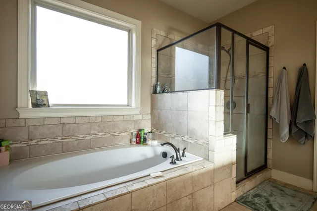 a bathroom with a bathtub and a shower