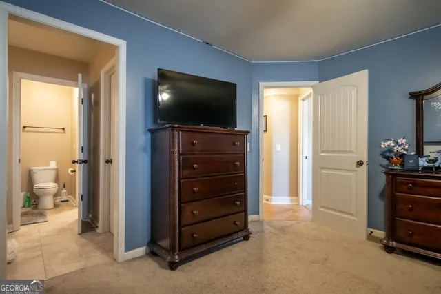 a room with a television and a dresser