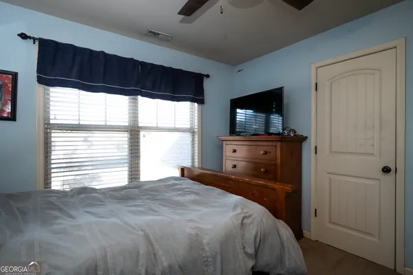 a bedroom with a bed and a television