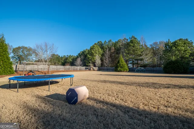 a view of outdoor space with garden and trees