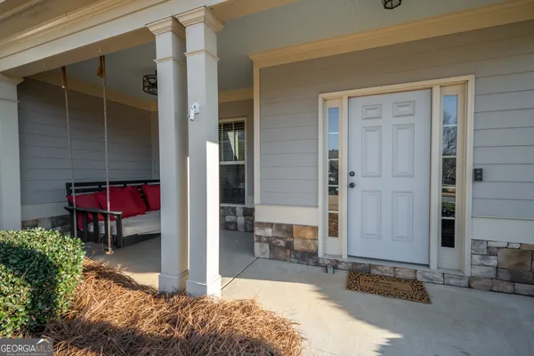 a view of front door of a house with outdoor seating