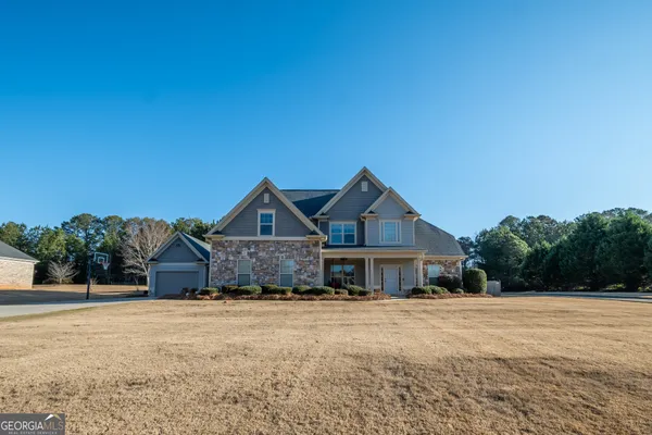 a front view of a house with a yard and garage