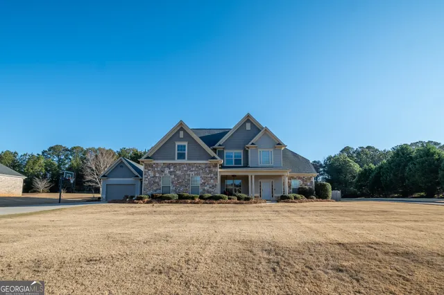 a front view of a house with a yard and garage