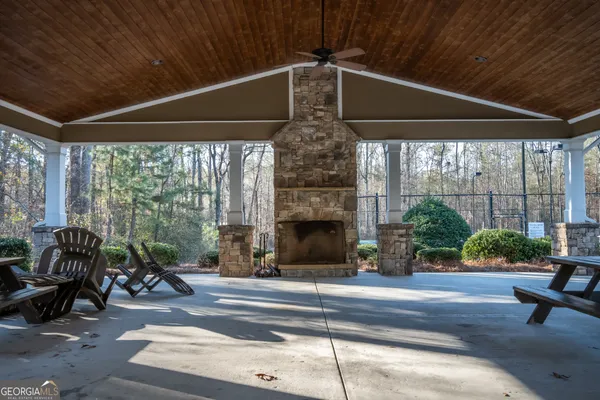 a building outdoor space with patio furniture and potted plants