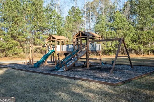 a view of outdoor space with playground and green space