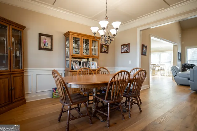 a view of a dining room with furniture wooden floor and chandelier
