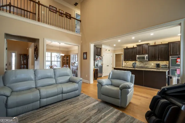 a living room with furniture and kitchen view