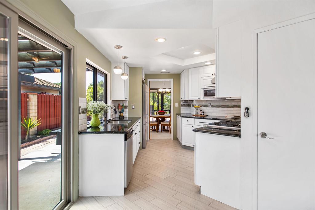 5312 Ontario Street Oceanside, CA 92056 - Photo 12 of 48 a kitchen with stainless steel appliances kitchen island a stove and a refrigerator