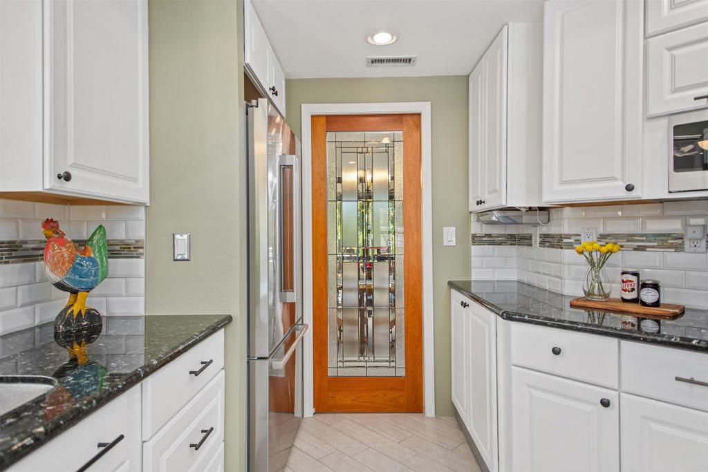 5312 Ontario Street Oceanside, CA 92056 - Photo 15 of 48 a kitchen with stainless steel appliances granite countertop a refrigerator and a sink