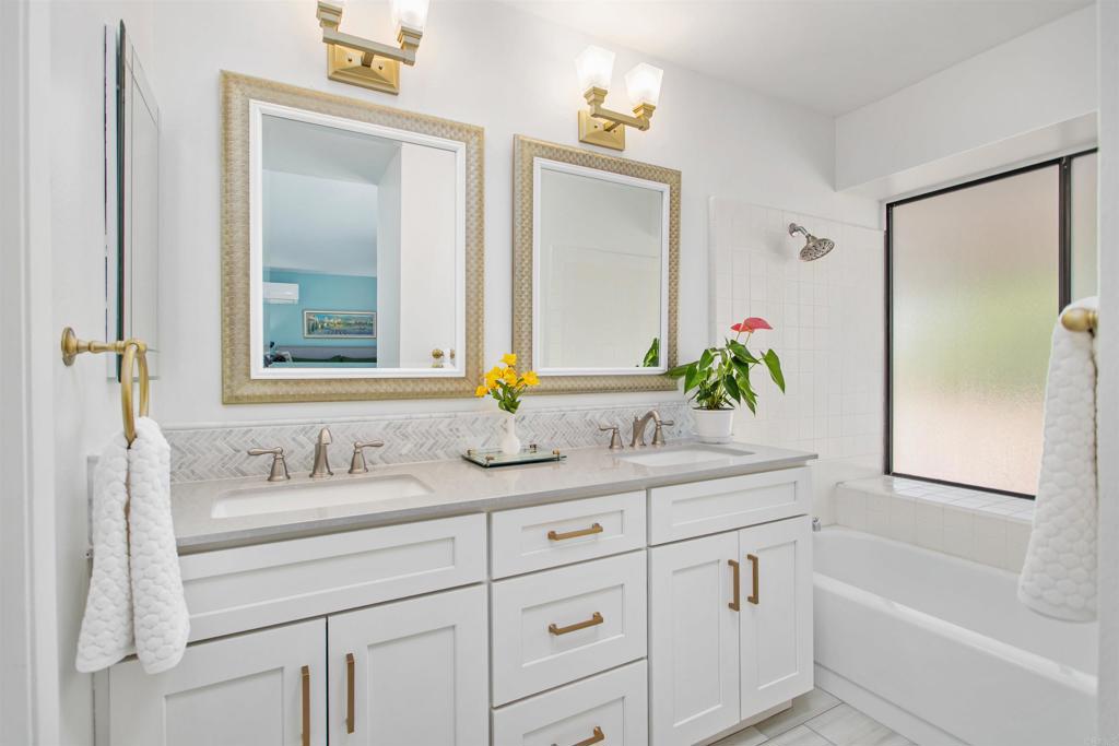 5312 Ontario Street Oceanside, CA 92056 - Photo 25 of 48 a bathroom with a granite countertop sink and a mirror