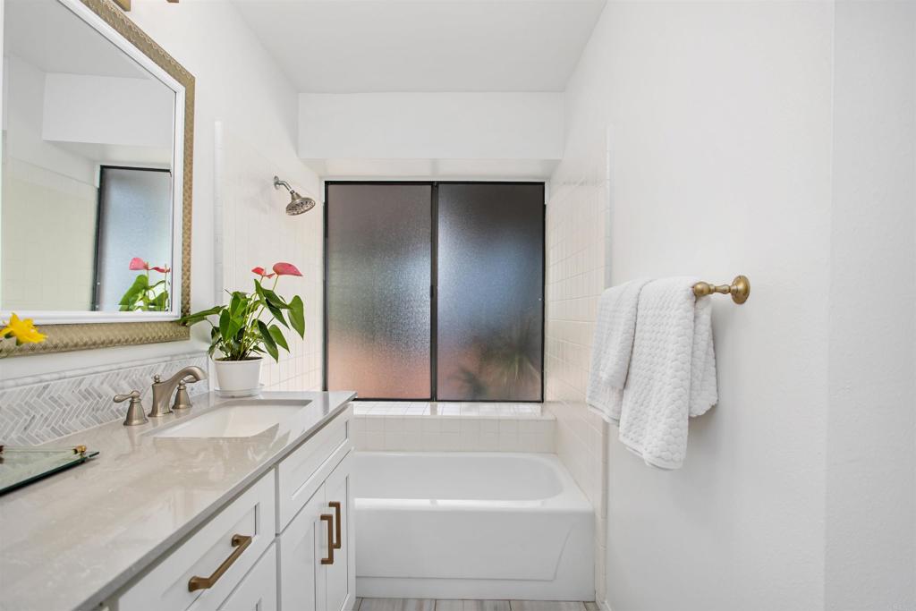 5312 Ontario Street Oceanside, CA 92056 - Photo 26 of 48 a bathroom with a granite countertop sink and a mirror