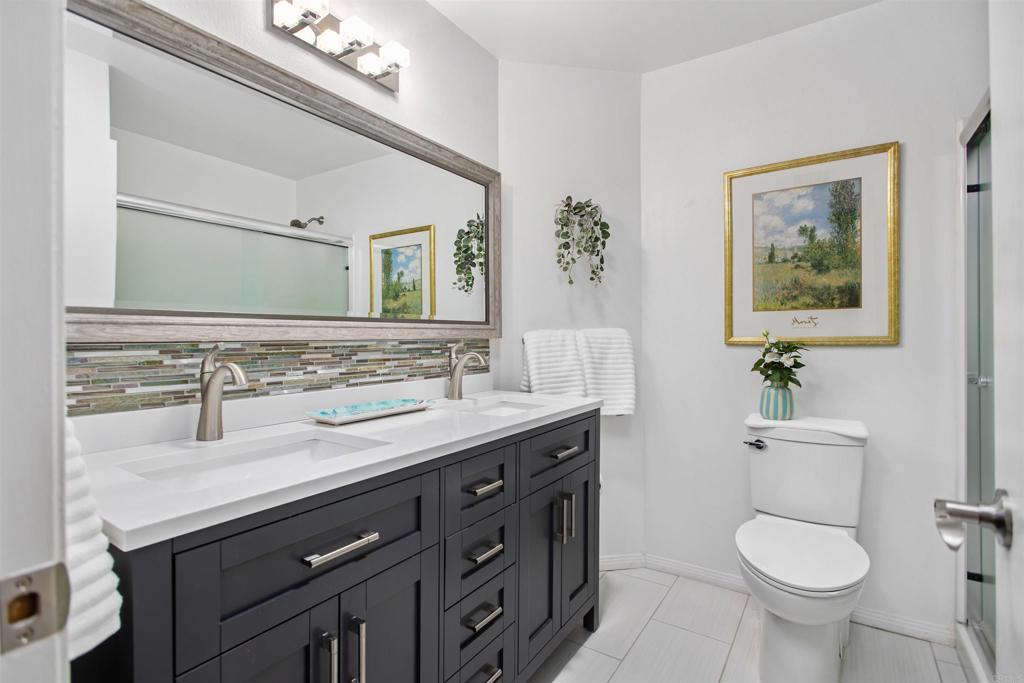 5312 Ontario Street Oceanside, CA 92056 - Photo 29 of 48 a bathroom with a toilet sink and mirror