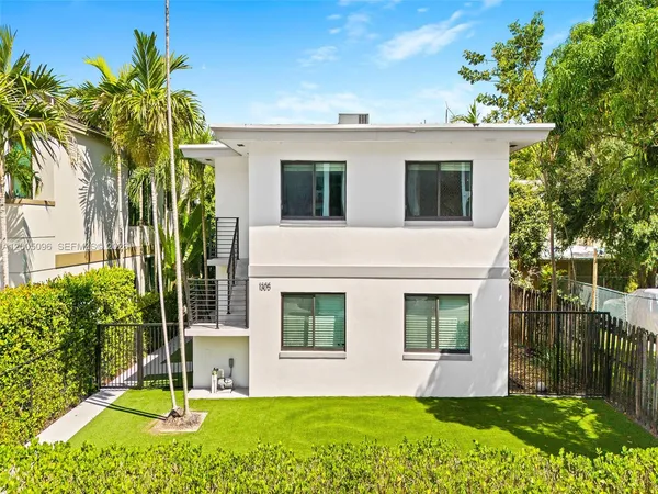 a view of an house with backyard space and garden