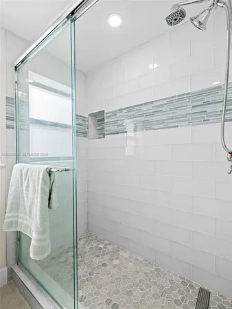 a bathroom with a glass shower door