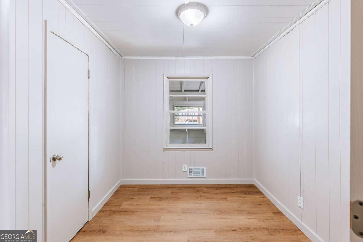 52 Clark Circle Lexington, GA 30648 - Photo 13 of 47 a view of an empty room with a window and wooden floor