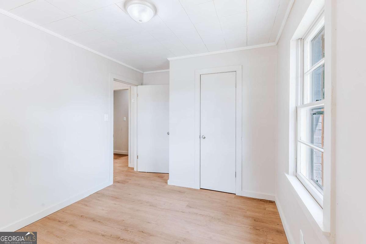 52 Clark Circle Lexington, GA 30648 - Photo 17 of 47 a view of an empty room with wooden floor and a window