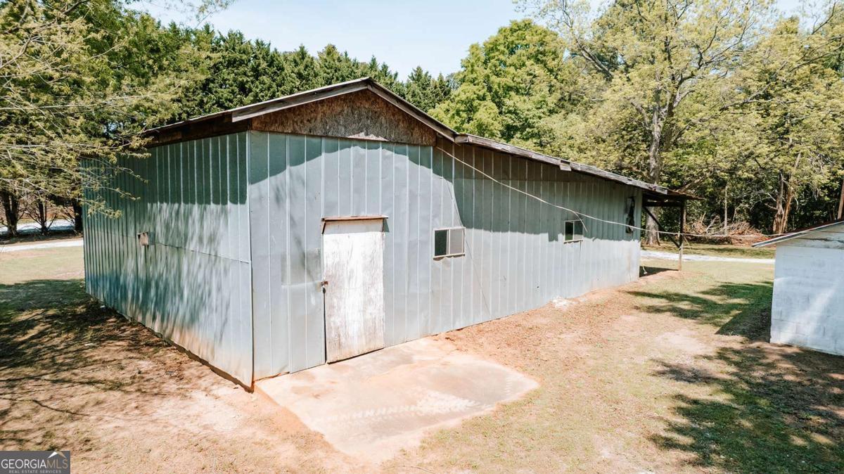 52 Clark Circle Lexington, GA 30648 - Photo 31 of 47 a pathway of a house with a small yard