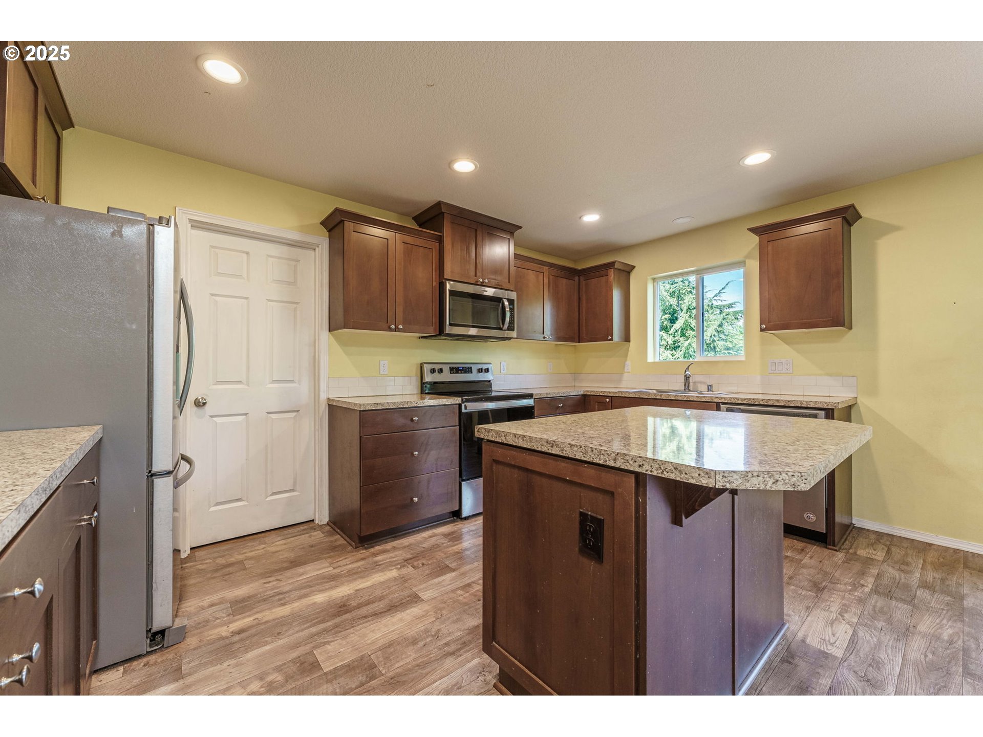 282 Karousel Lane Washougal, WA 98671 - Photo 12 of 42 a kitchen with stainless steel appliances granite countertop a sink stove and refrigerator