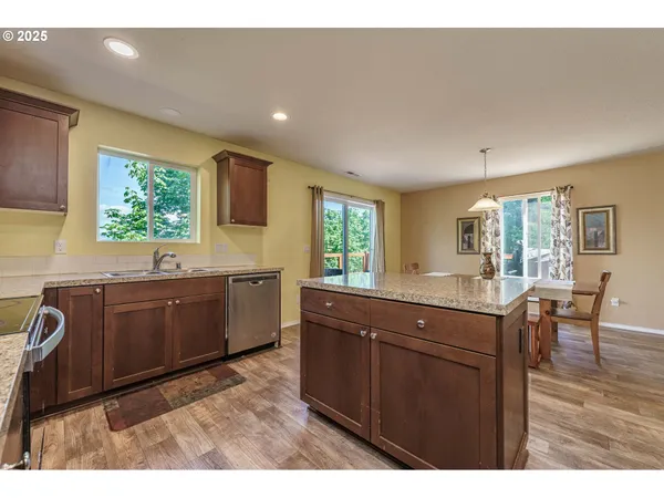 a kitchen with stainless steel appliances granite countertop a sink and cabinets