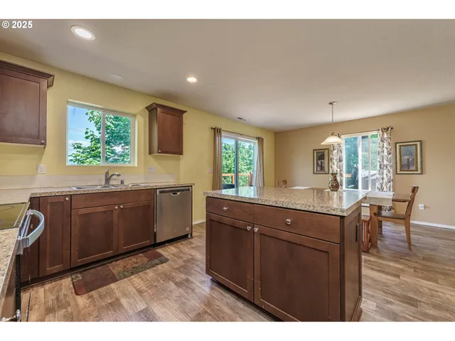 a kitchen with stainless steel appliances granite countertop a sink and cabinets