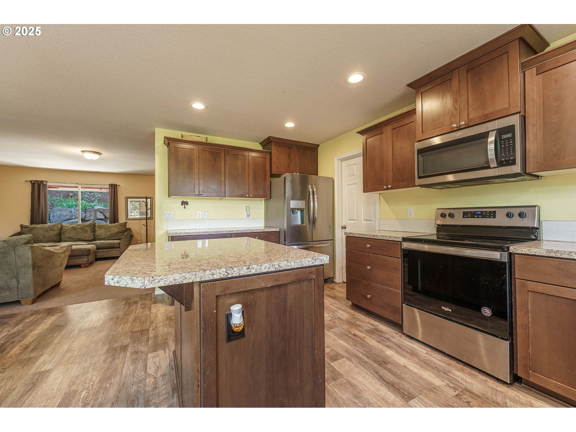 282 Karousel Lane Washougal, WA 98671 - Photo 15 of 42 a kitchen with stainless steel appliances granite countertop a stove a sink and a microwave