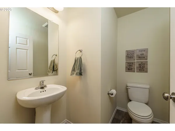 a bathroom with a sink toilet and mirror