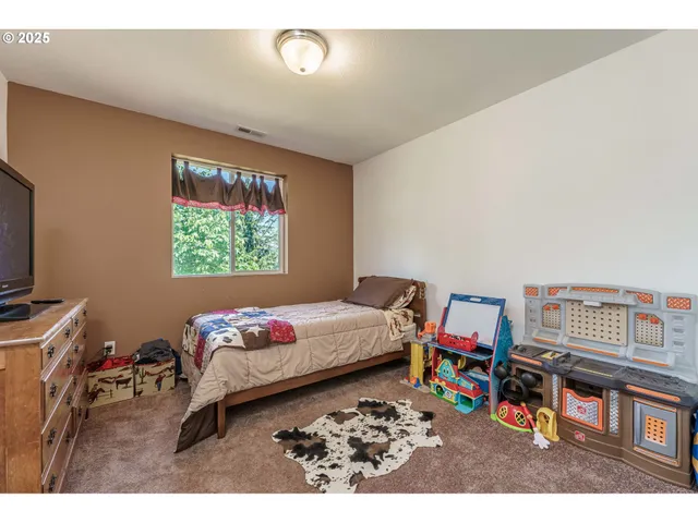 a bed room with a bed window and a table