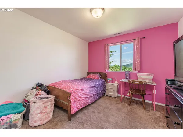 a bedroom with a bed and a table