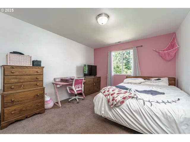 a bedroom with a bed and a dresser