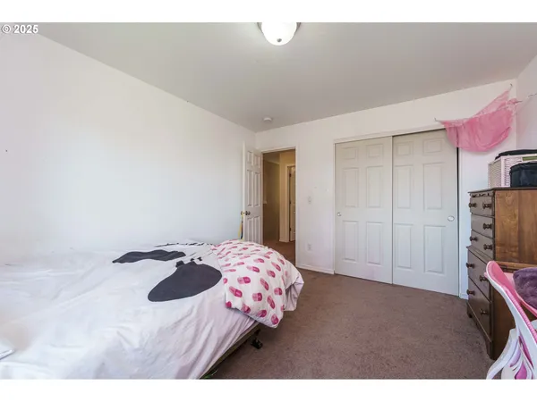 a bedroom with a bed and a television