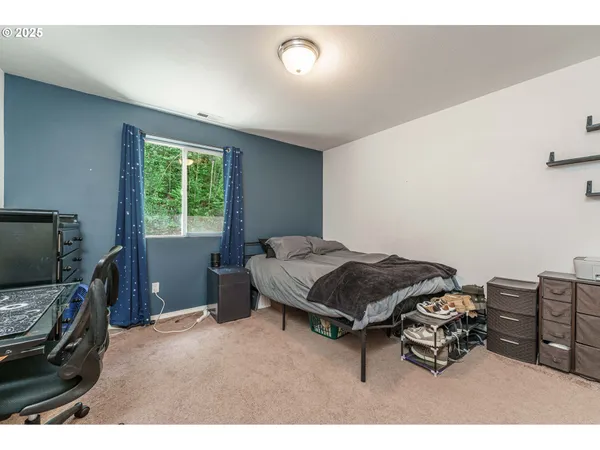 a bedroom with furniture and a flat tv screen