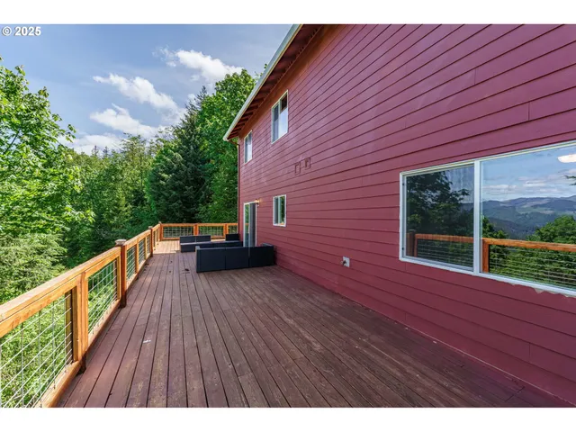 a view of house with backyard and deck