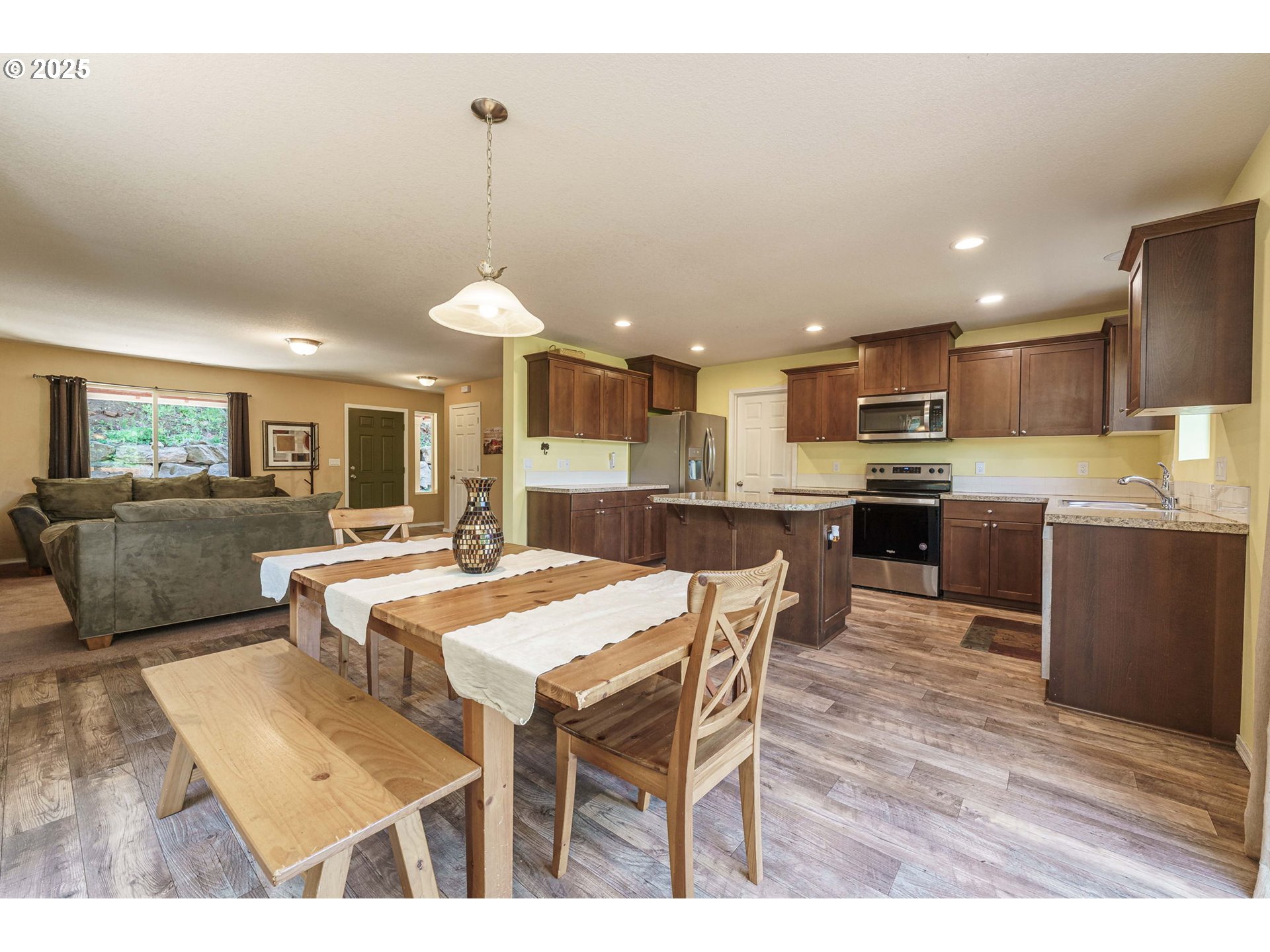 282 Karousel Lane Washougal, WA 98671 - Photo 10 of 42 a open kitchen with stainless steel appliances kitchen island granite countertop a dining table chairs and a refrigerator