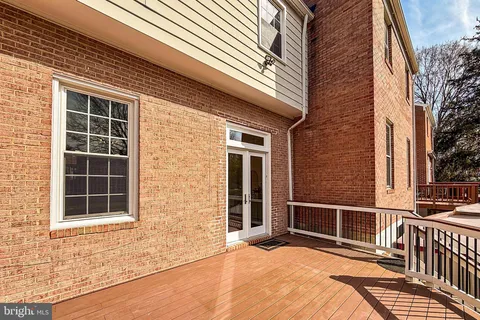 a view of backyard with brick wall