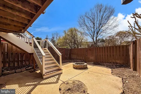 a view of a yard with wooden fence