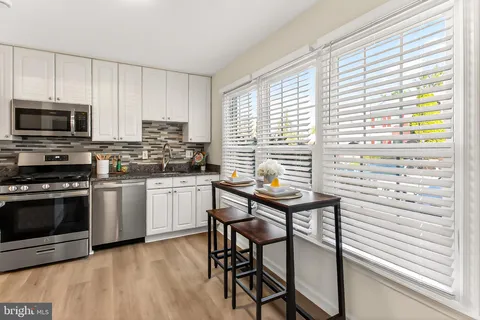 a kitchen with stainless steel appliances and wooden cabinets