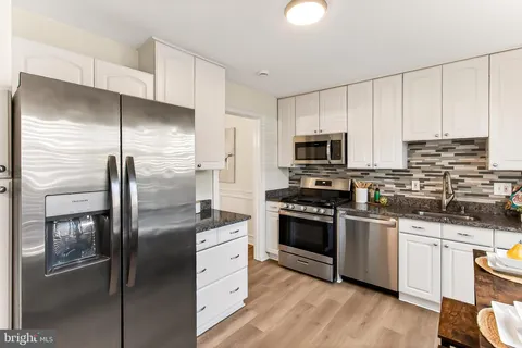 a kitchen with granite countertop cabinets and stainless steel appliances