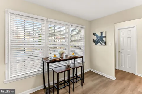 a kitchen with stainless steel appliances granite countertop white cabinets a stove top oven a sink and dishwasher