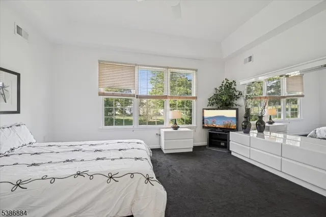 a bedroom with a large bed and a window