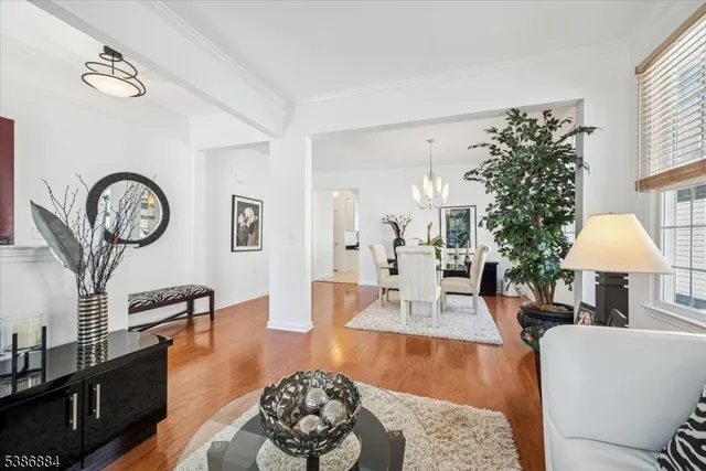 a living room with furniture a clock and a large mirror
