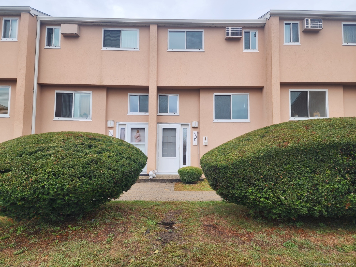 a view of a brick building next to a yard