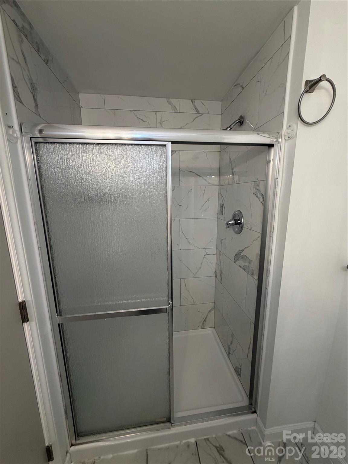 9333 Old Concord Road, Unit J Charlotte, NC 28213 - Photo 15 of 18 a bathroom with a glass shower door