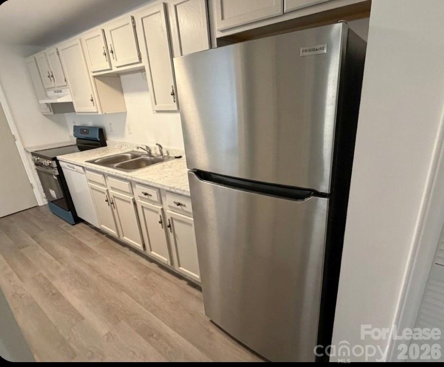 9333 Old Concord Road, Unit J Charlotte, NC 28213 - Photo 3 of 18 a kitchen with stainless steel appliances granite countertop a refrigerator and a stove